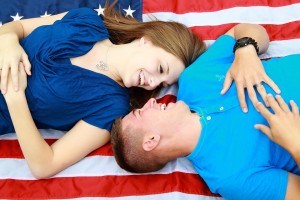 Couple laying on USA flag enjoying the benefits of VA Loans